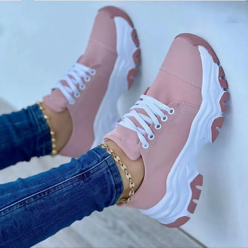 Women's platform lace-up sneaker with rubber sole, round toe, and thick platform in solid red colour