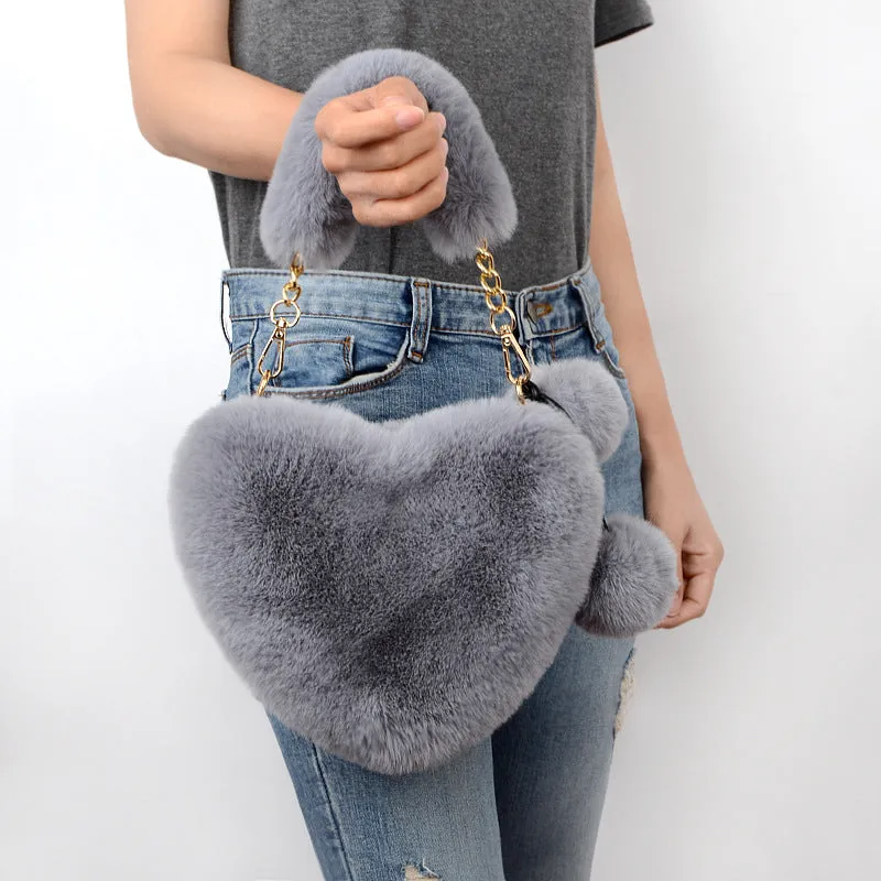 Love Bags soft plush heart-shaped handbag with zipper closure and removable handle in solid colour