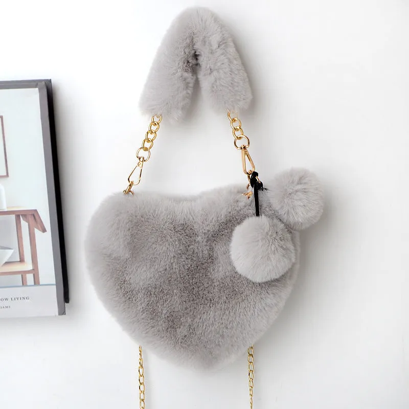 Love Bags soft plush heart-shaped handbag with zipper closure and removable handle in solid colour