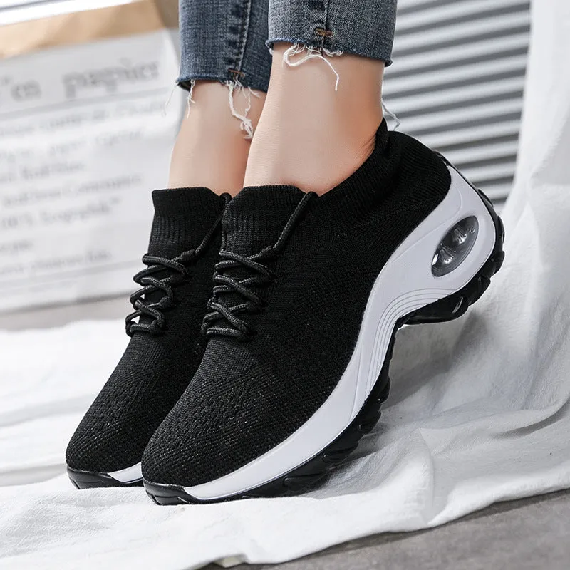 Women's flying knit platform sneakers in black with round toe and waterproof sole