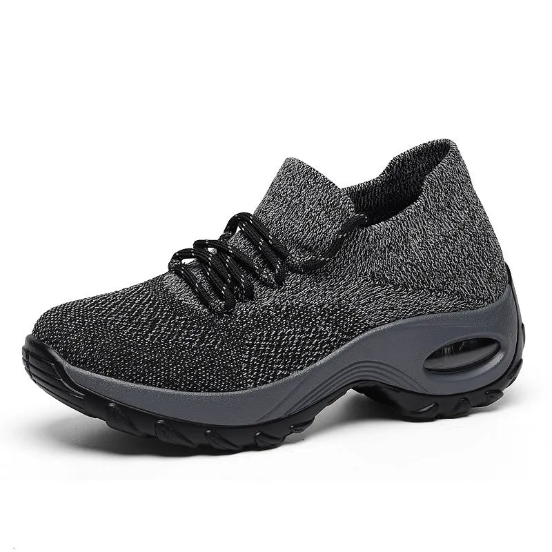Women's flying knit platform sneakers in black with round toe and waterproof sole
