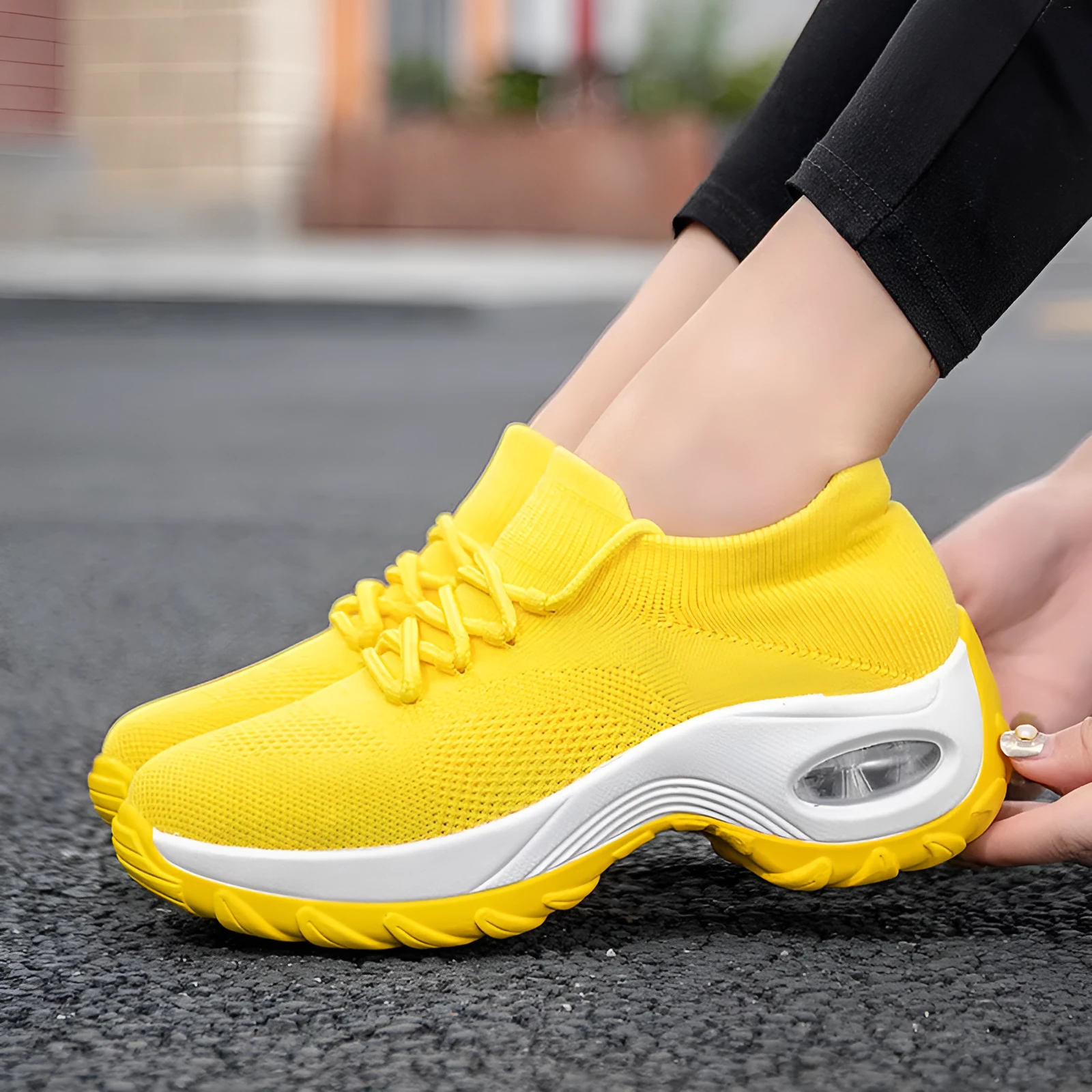Women's flying knit platform sneakers in black with round toe and waterproof sole