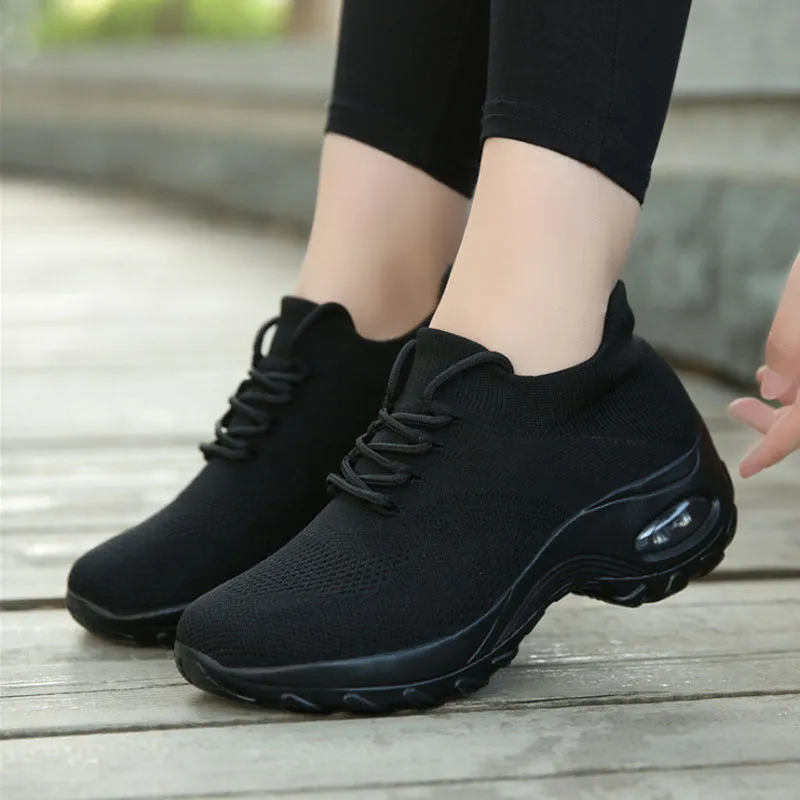 Women's flying knit platform sneakers in black with round toe and waterproof sole