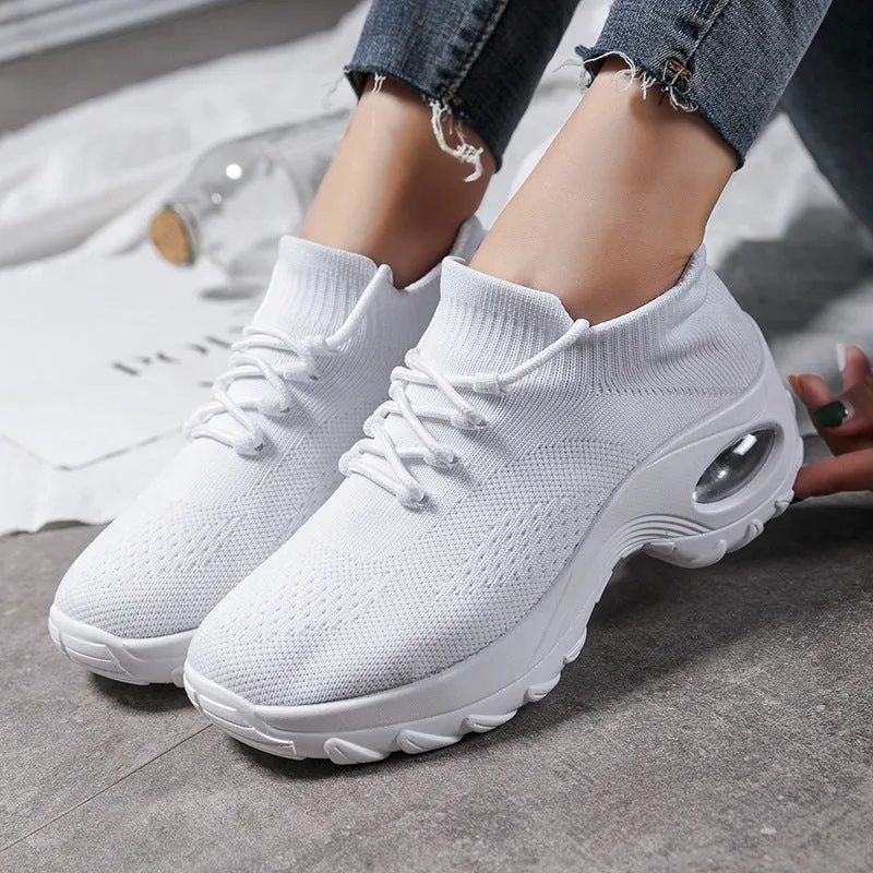 Women's flying knit platform sneakers in black with round toe and waterproof sole