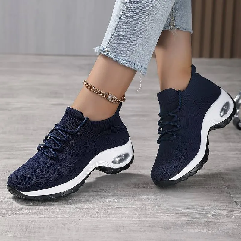 Women's flying knit platform sneakers in black with round toe and waterproof sole