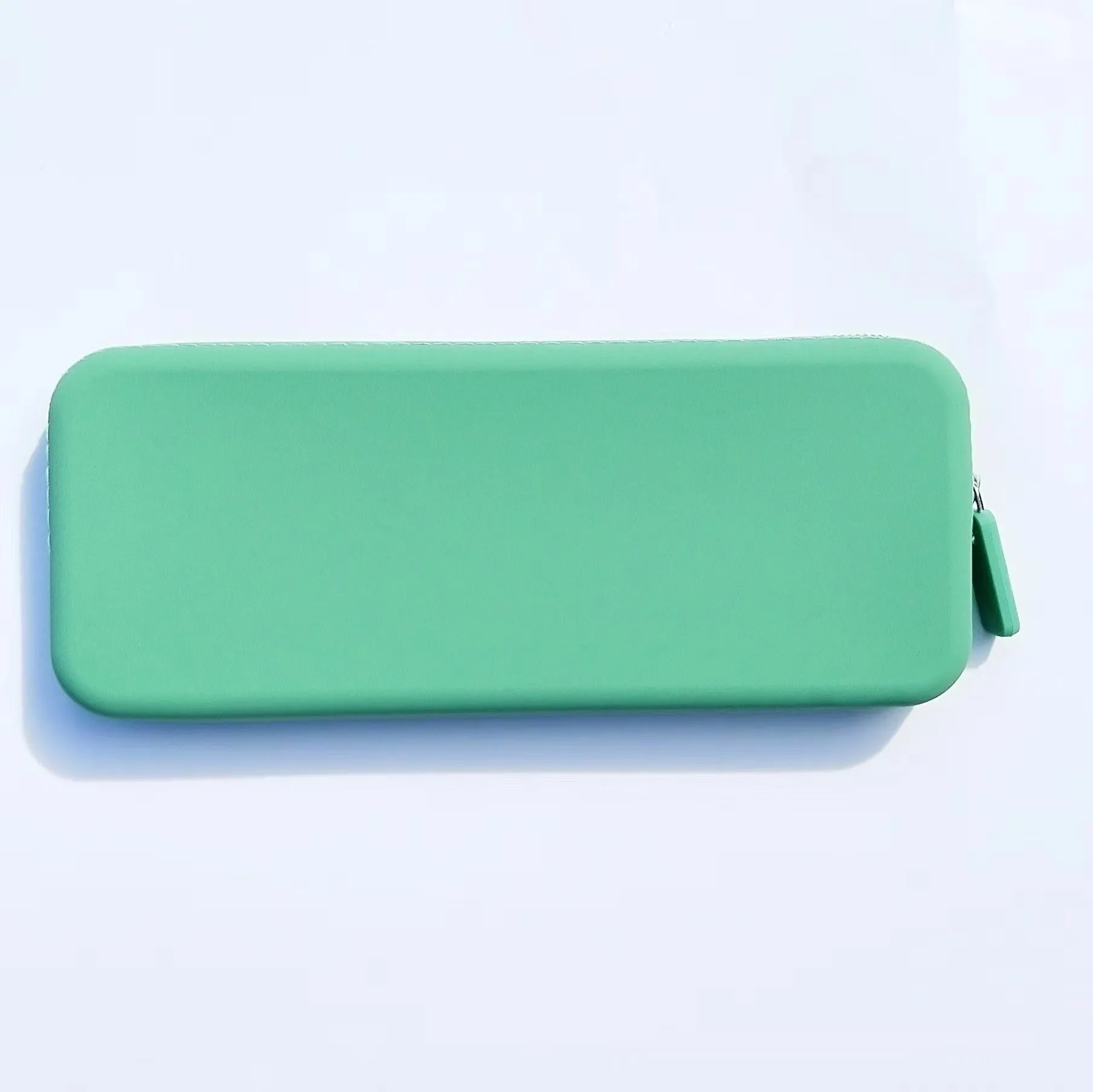 Slim silicone makeup brush storage bag in assorted colours, shown with brushes inside.