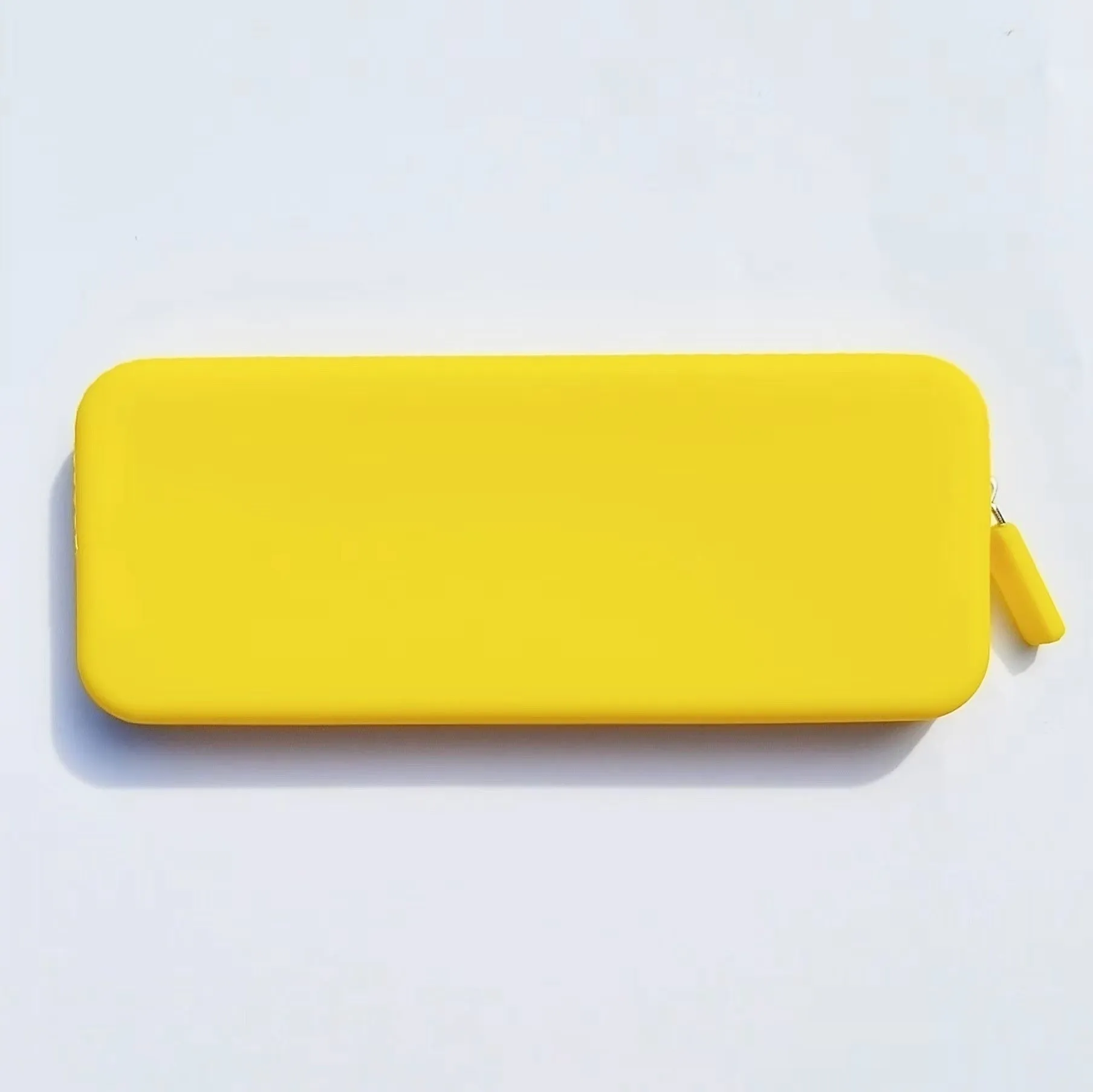 Slim silicone makeup brush storage bag in assorted colours, shown with brushes inside.