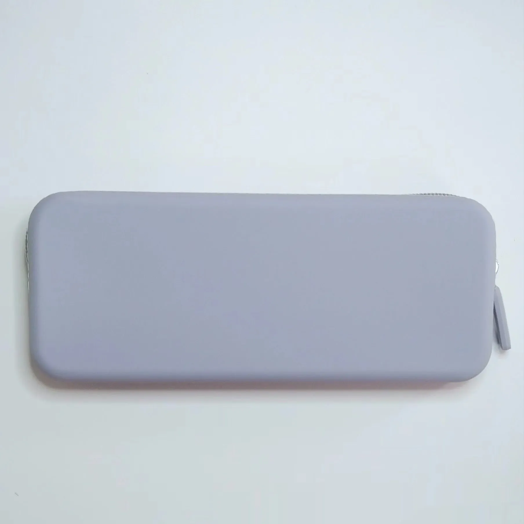 Slim silicone makeup brush storage bag in assorted colours, shown with brushes inside.