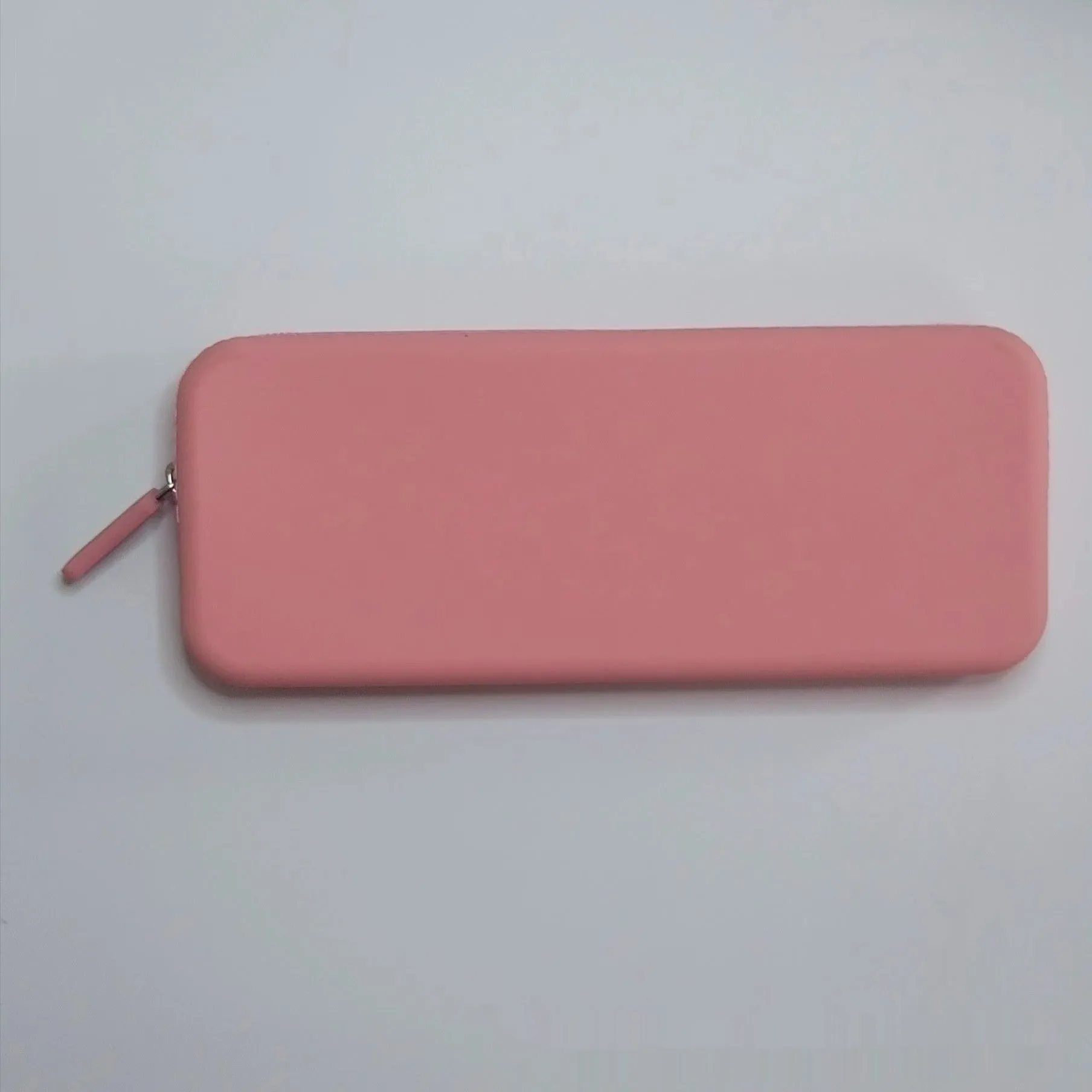 Slim silicone makeup brush storage bag in assorted colours, shown with brushes inside.