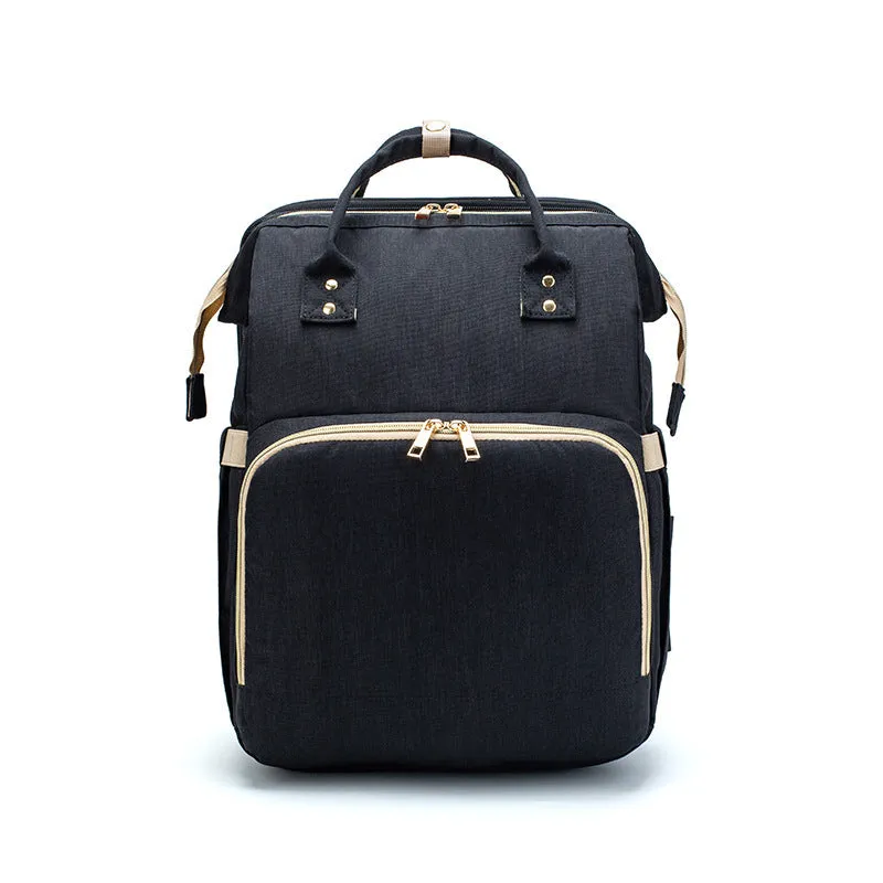 USB charging folding baby bed backpack with mattress in black, showing backpack and crib setup