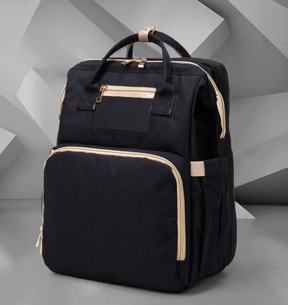 USB charging folding baby bed backpack with mattress in black, showing backpack and crib setup