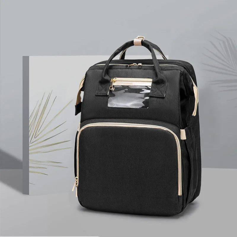 USB charging folding baby bed backpack with mattress in black, showing backpack and crib setup