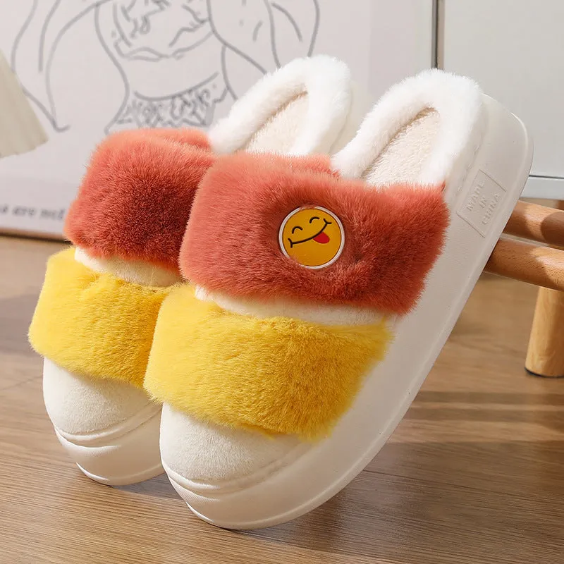 Pair of pink and green thermal cotton slippers with a plush upper and non-slip sole.