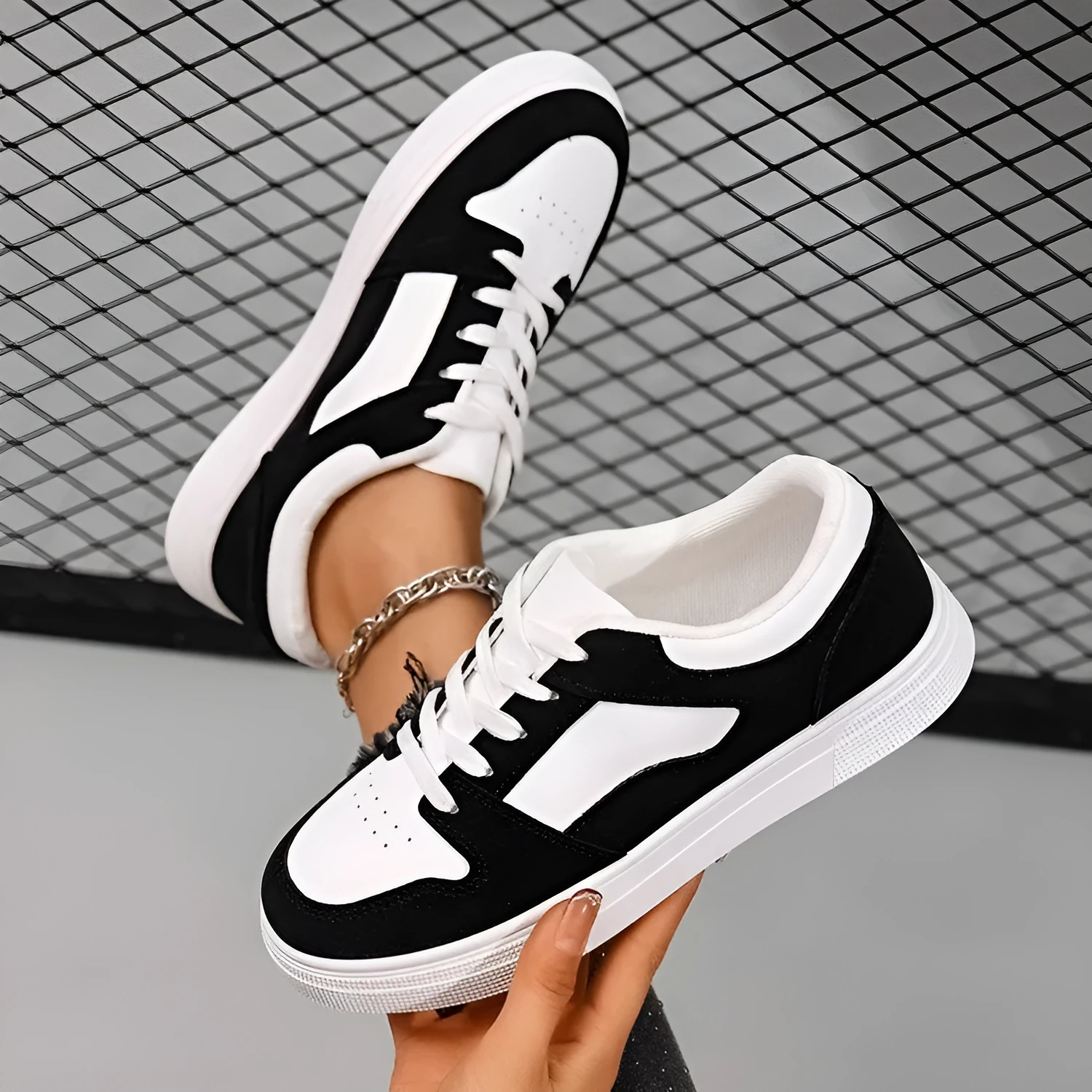 Black women's casual sports shoes with artificial PU upper and rubber sole, showing round toe and lace-up design