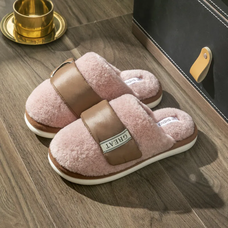 Beige plush velcro slippers with a round toe and non-slip plastic sole on a wooden floor.