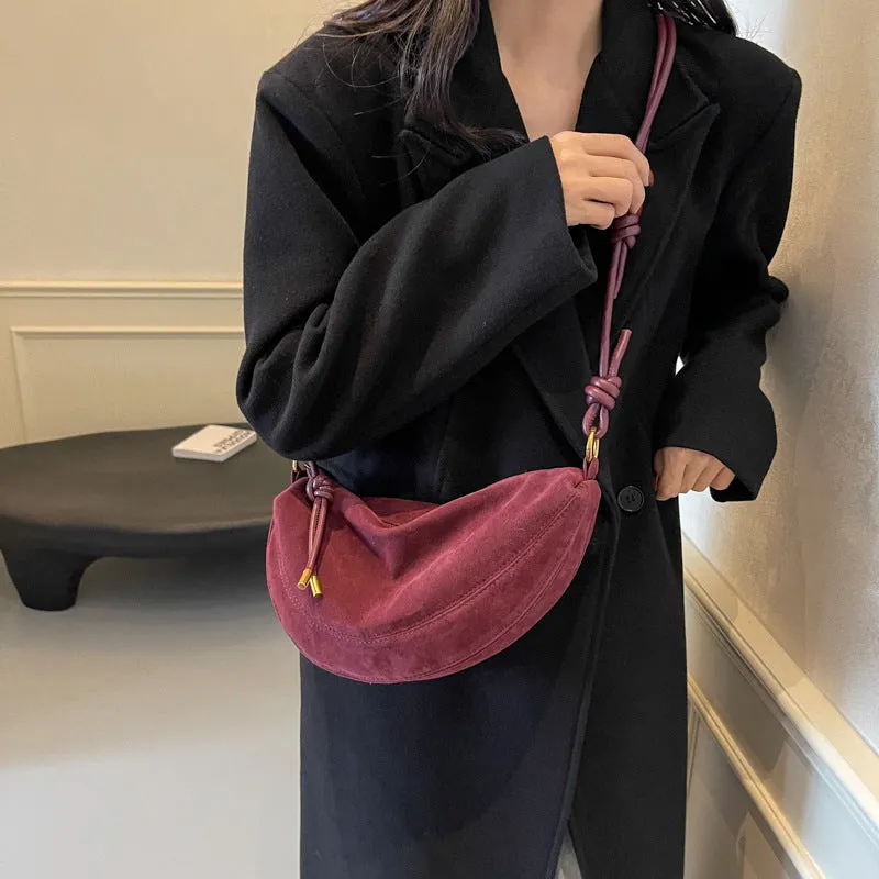 Soft PU crossbody underarm dumpling bag in black with visible sewing line detail