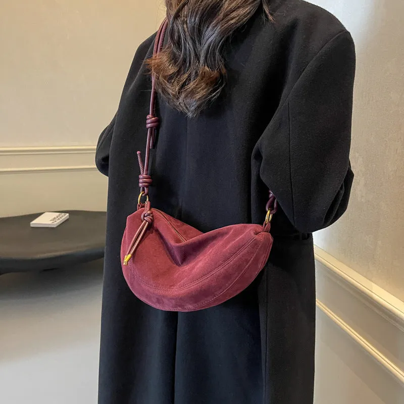 Soft PU crossbody underarm dumpling bag in black with visible sewing line detail