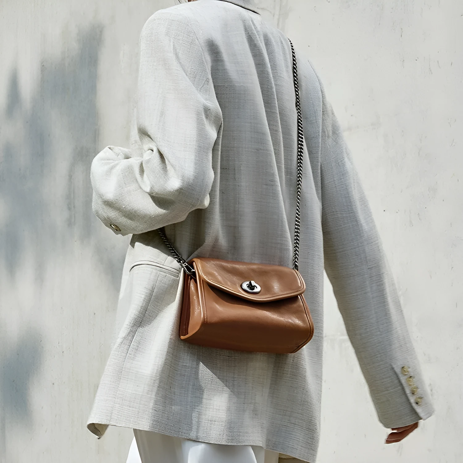Small genuine leather messenger bag in Black with envelope flap and single shoulder strap