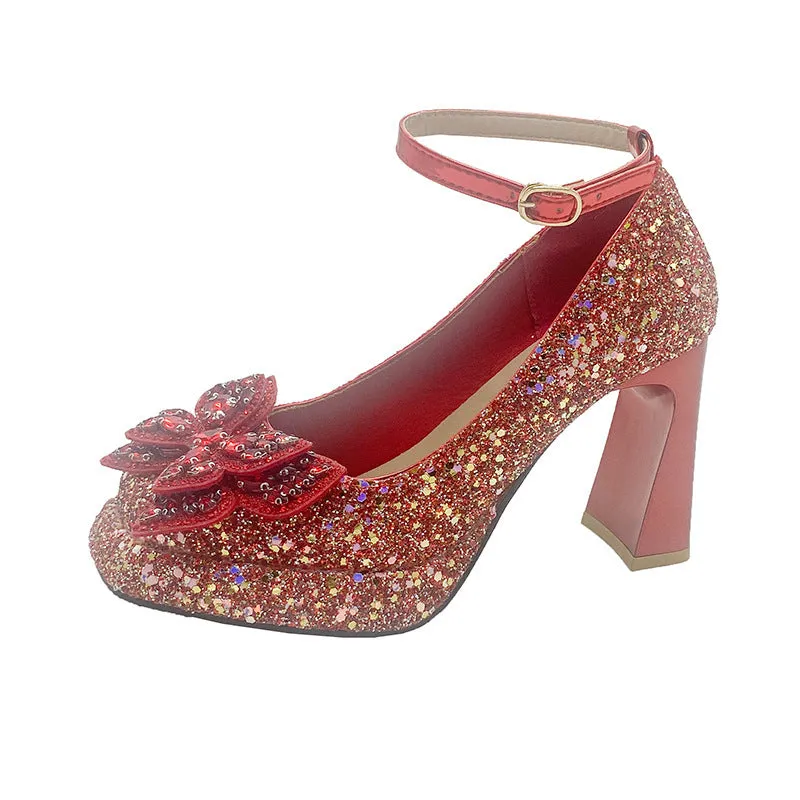 Women's crystal sequined high heels in silver with short stout heel and buckle fastening on a white background