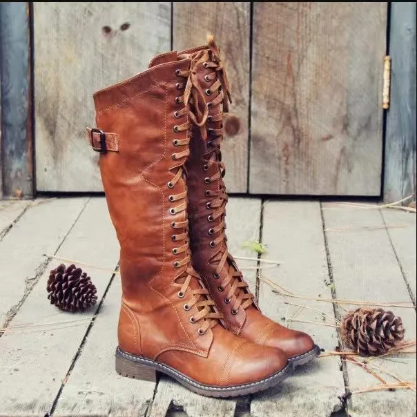 Brown high leg casual boots with a round toe and a chunky low heel on a plain background.