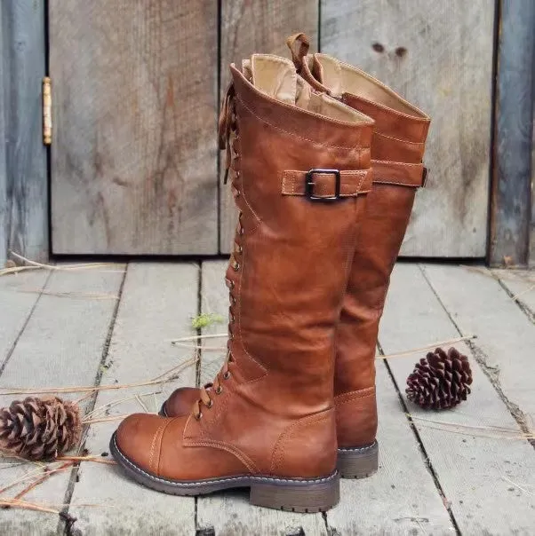 Brown high leg casual boots with a round toe and a chunky low heel on a plain background.