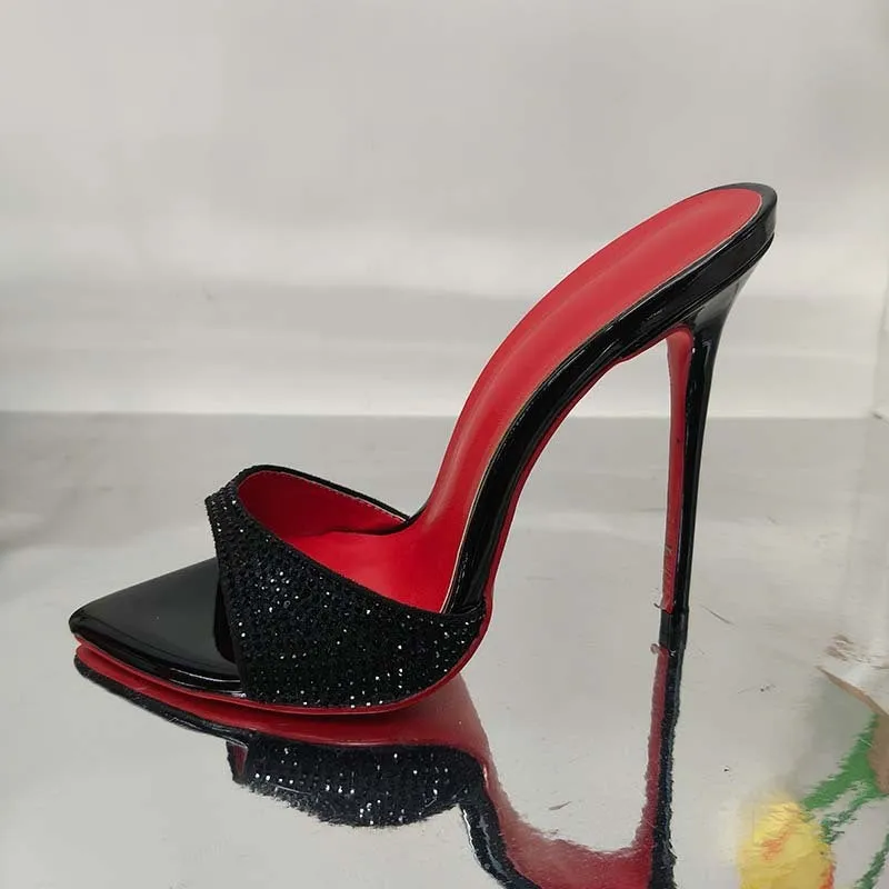 Black rhinestone ankle-strap open toe sandal with super high heel and pointed toe on white background