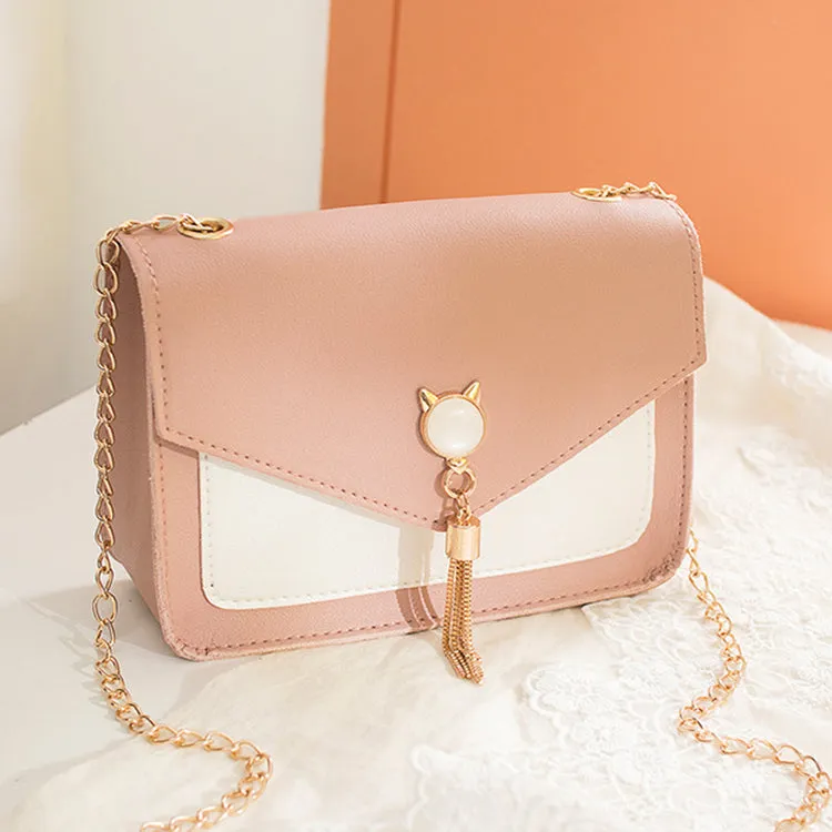 Small square PU leather crossbody bag with cat tassel decoration, magnetic flap, and adjustable chain strap in black