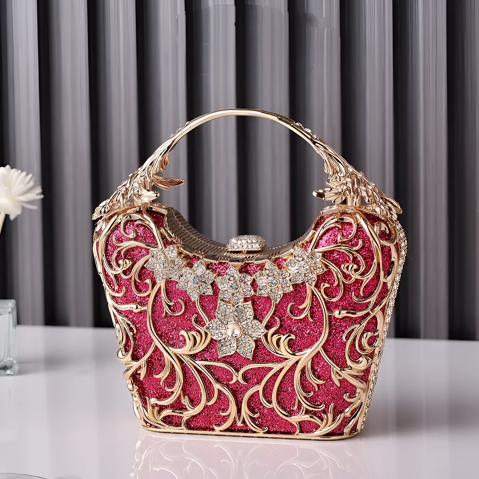 Silver hollow-out party clutch with shiny finish, flower motif, and bucket shape on a plain background