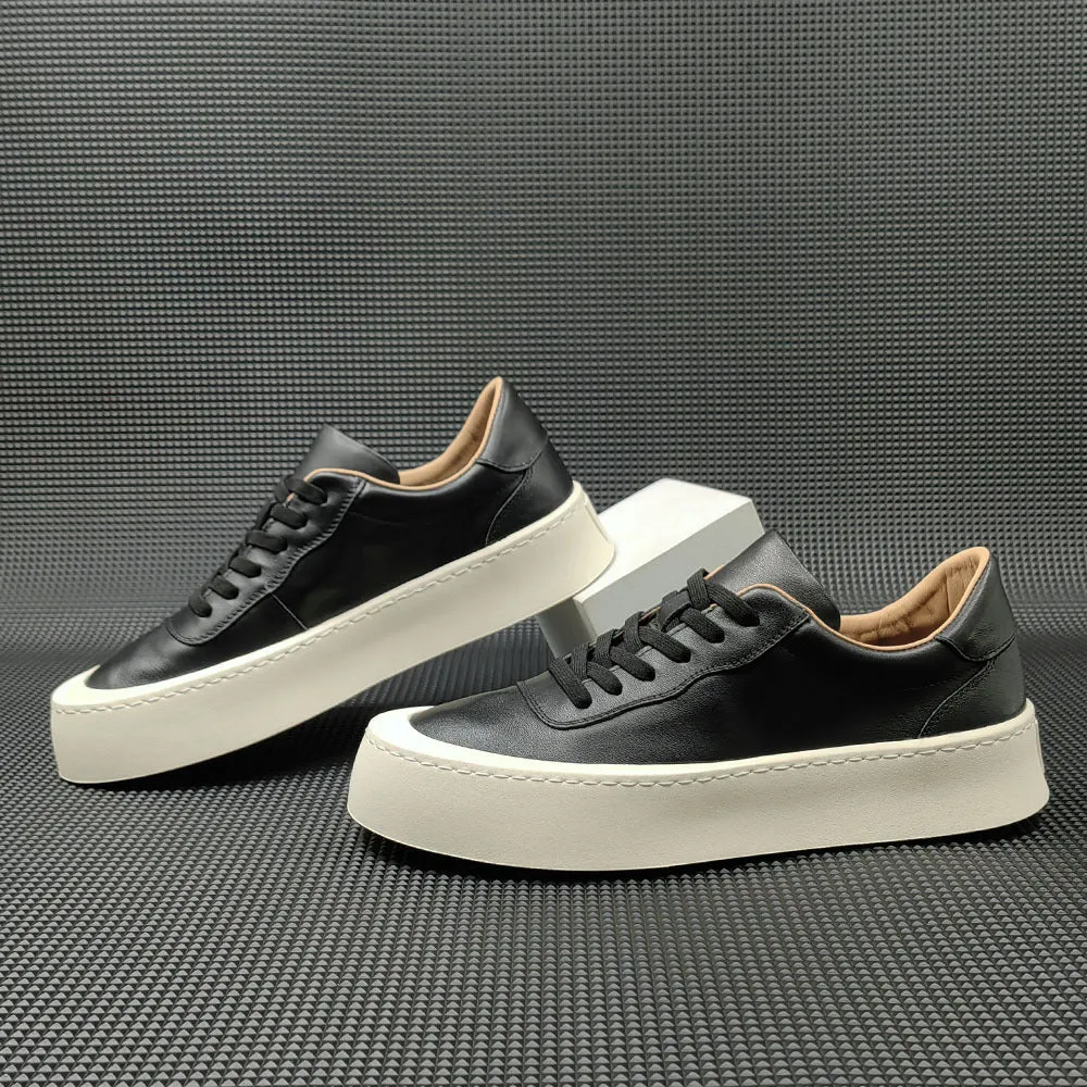 Boys black cowhide leather platform board shoes with a thick rubber sole and white stitching.