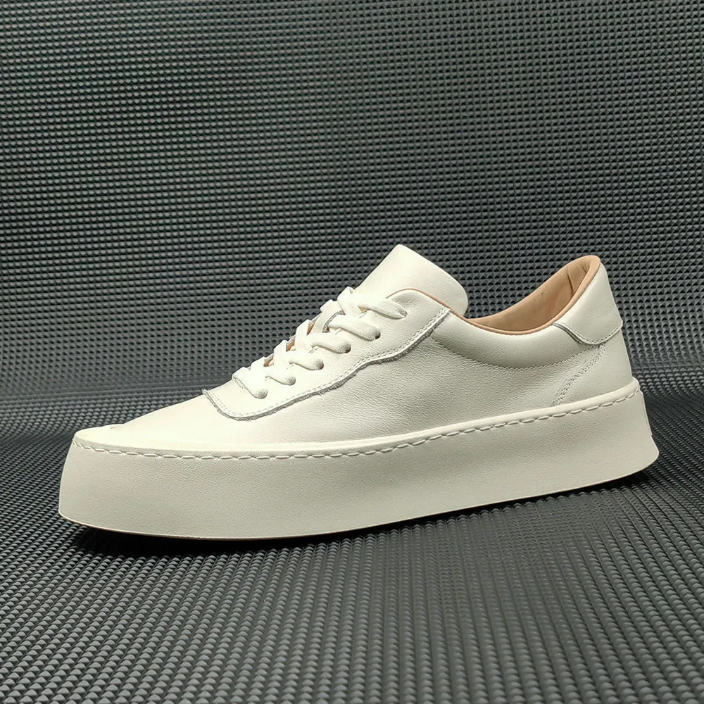 Boys black cowhide leather platform board shoes with a thick rubber sole and white stitching.