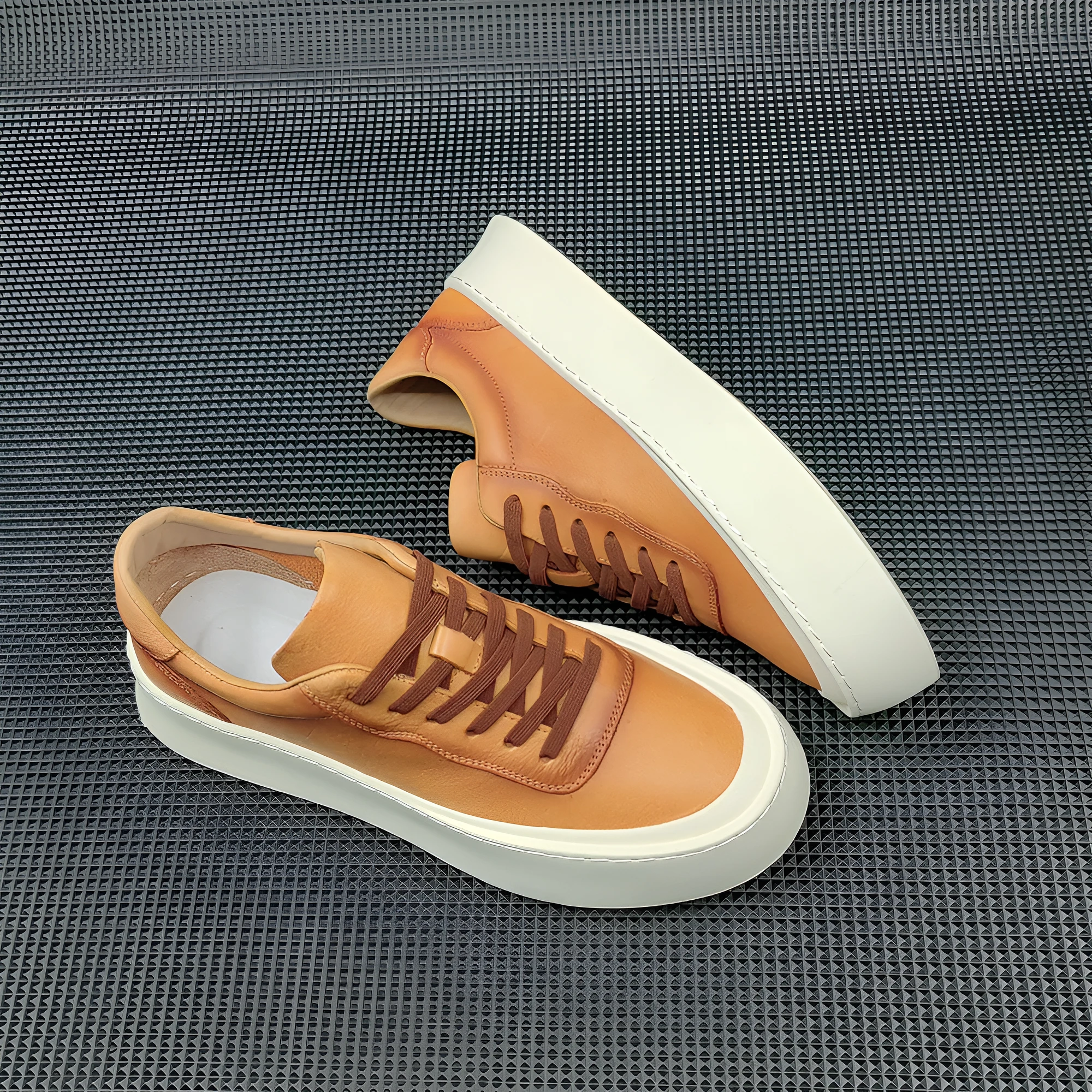 Boys black cowhide leather platform board shoes with a thick rubber sole and white stitching.