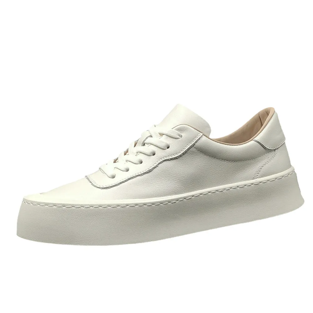 Boys black cowhide leather platform board shoes with a thick rubber sole and white stitching.