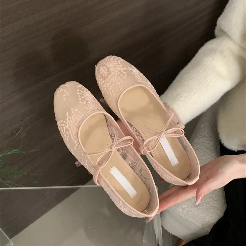 Women's pink flat lace mesh Mary Jane evening shoes with a mid heel on a white background.