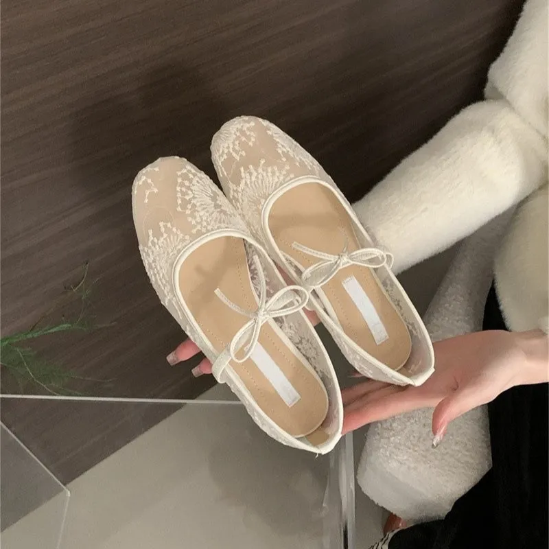 Women's pink flat lace mesh Mary Jane evening shoes with a mid heel on a white background.