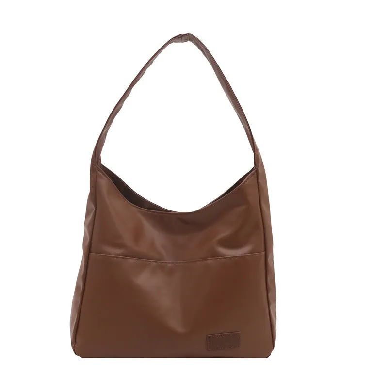 Women's retro large capacity PU bucket tote bag in Korean style with sewing thread detail, shown in coffee colour