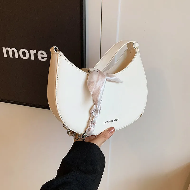 Small PU leather saddle bag on a flat surface, available in black, brown, coffee, green, khaki, and white