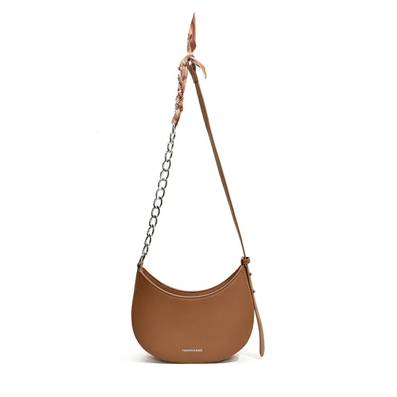 Small PU leather saddle bag on a flat surface, available in black, brown, coffee, green, khaki, and white