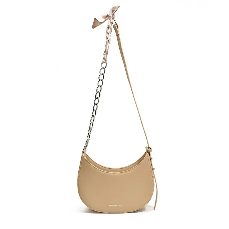 Small PU leather saddle bag on a flat surface, available in black, brown, coffee, green, khaki, and white