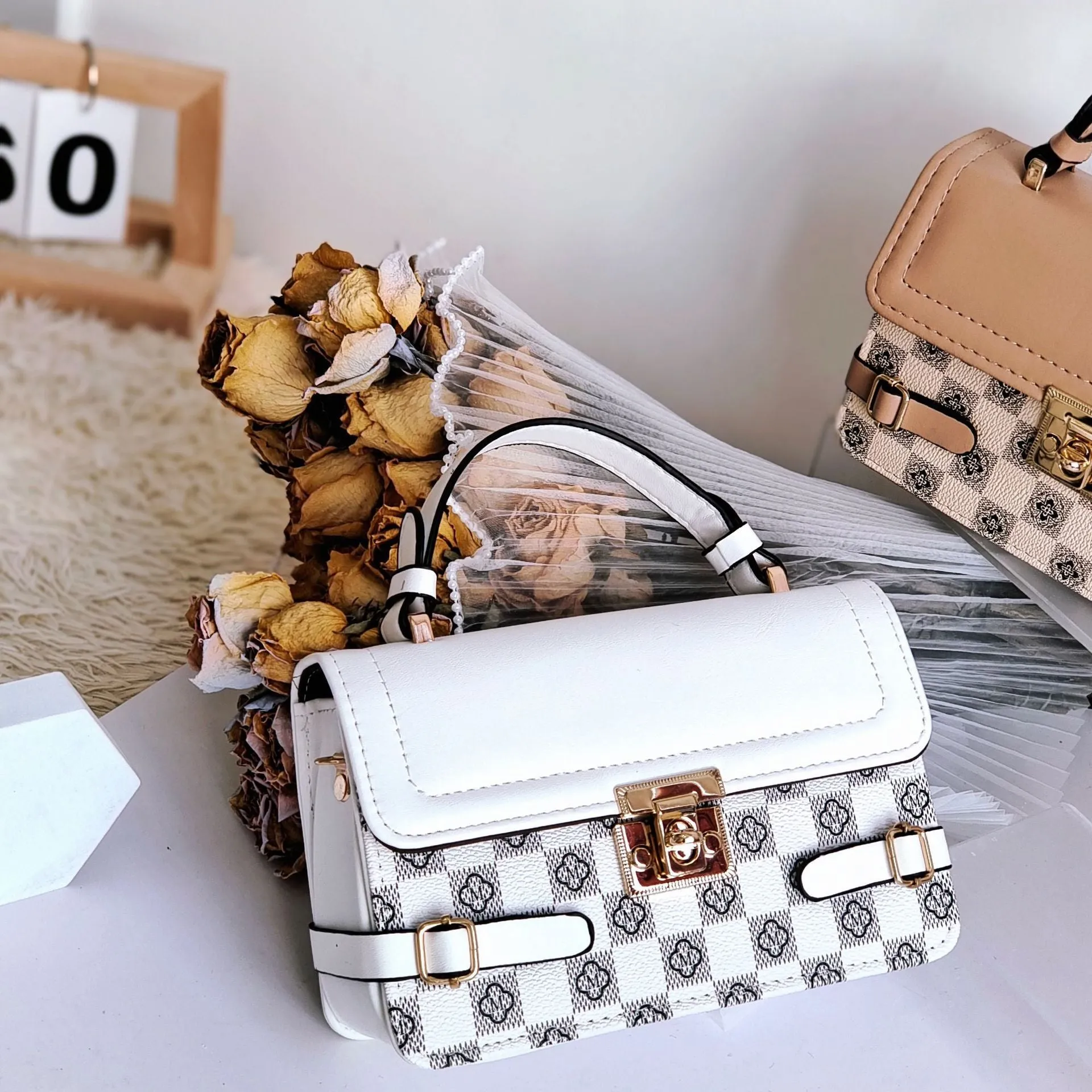 Retro small square pattern crossbody bag in apricot colour, showing horizontal square shape and stitching detail.