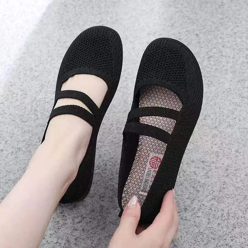 A pair of casual slip-on flat shoes with a round toe and elastic fabric upper, shown in an embroidered colour option.