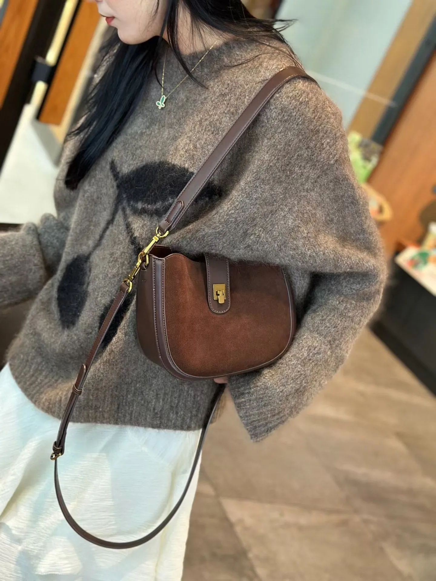 Women's brown genuine leather one-shoulder crossbody bag with a front sandwich pocket