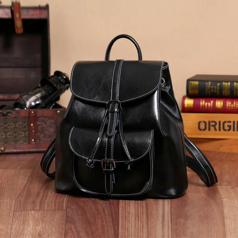 Korean style brown cowhide leather backpack with pull-belt fastening and front sandwich pocket.