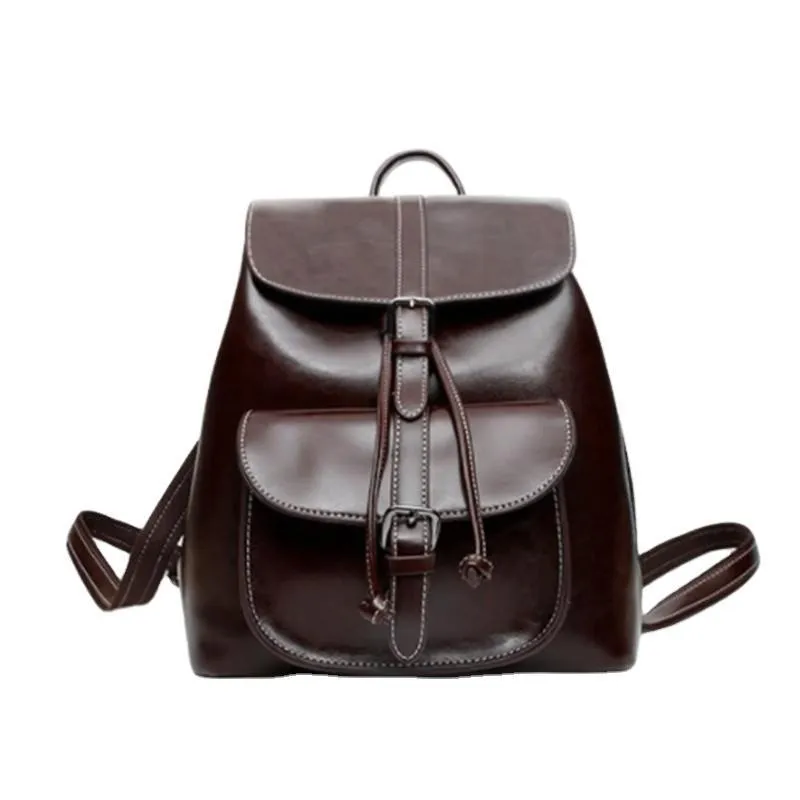 Korean style brown cowhide leather backpack with pull-belt fastening and front sandwich pocket.
