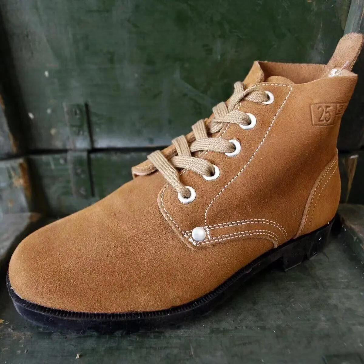 Brown film-coated leather safety boots with leather splicing, steel toe, high shaft, and rubber sole
