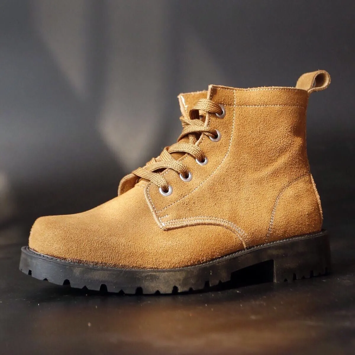 Brown film-coated leather safety boots with leather splicing, steel toe, high shaft, and rubber sole