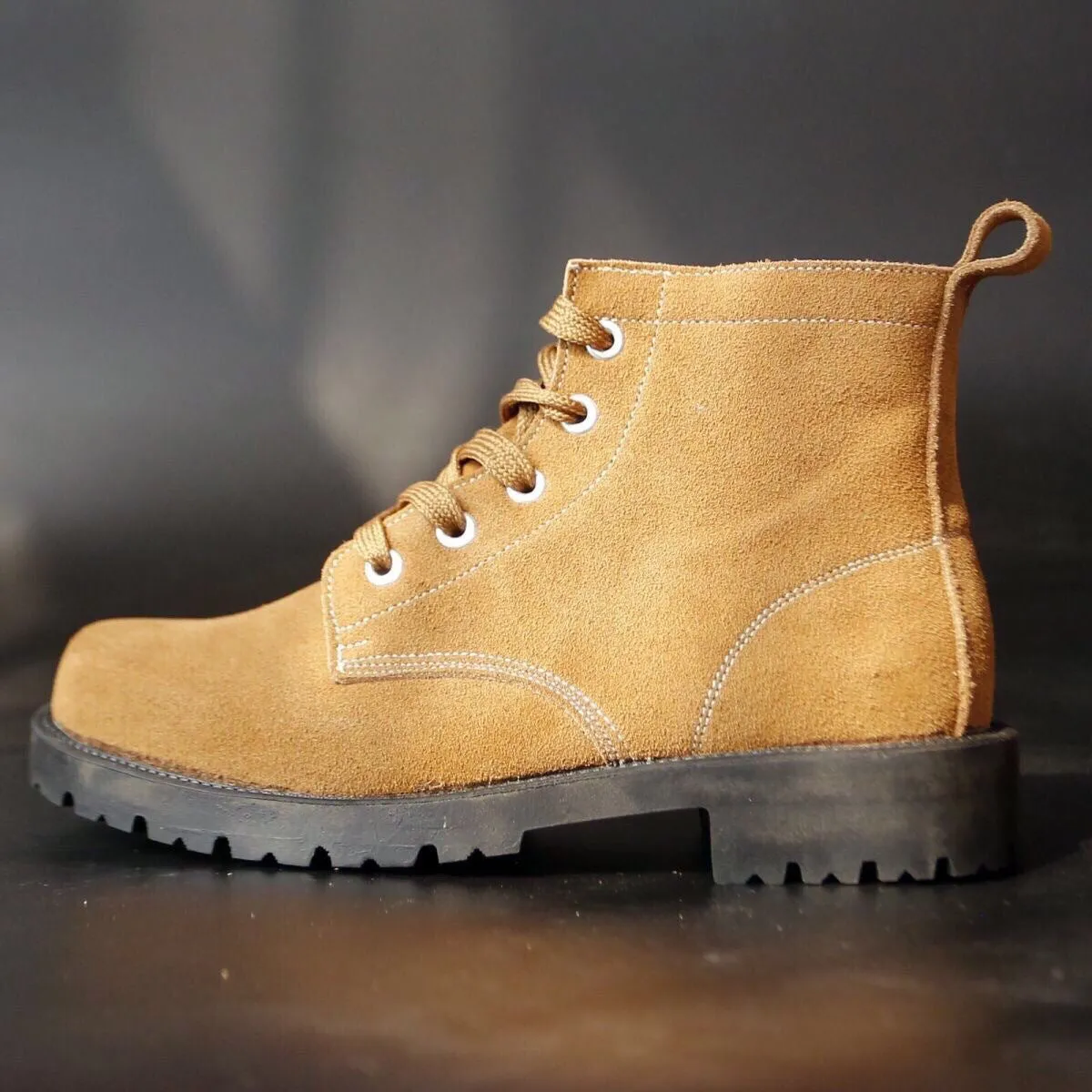 Brown film-coated leather safety boots with leather splicing, steel toe, high shaft, and rubber sole