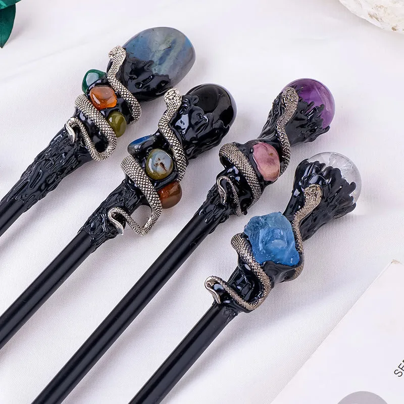 Natural crystal ball truncheon magic wand with amethyst stone ball on dark background