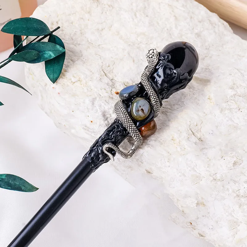 Natural crystal ball truncheon magic wand with amethyst stone ball on dark background