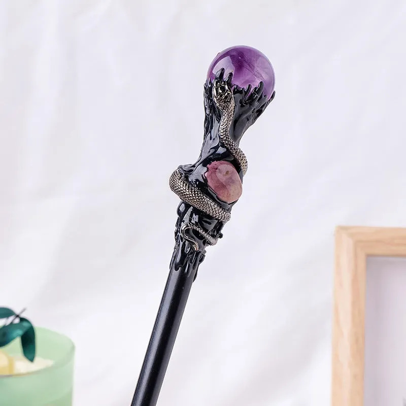 Natural crystal ball truncheon magic wand with amethyst stone ball on dark background