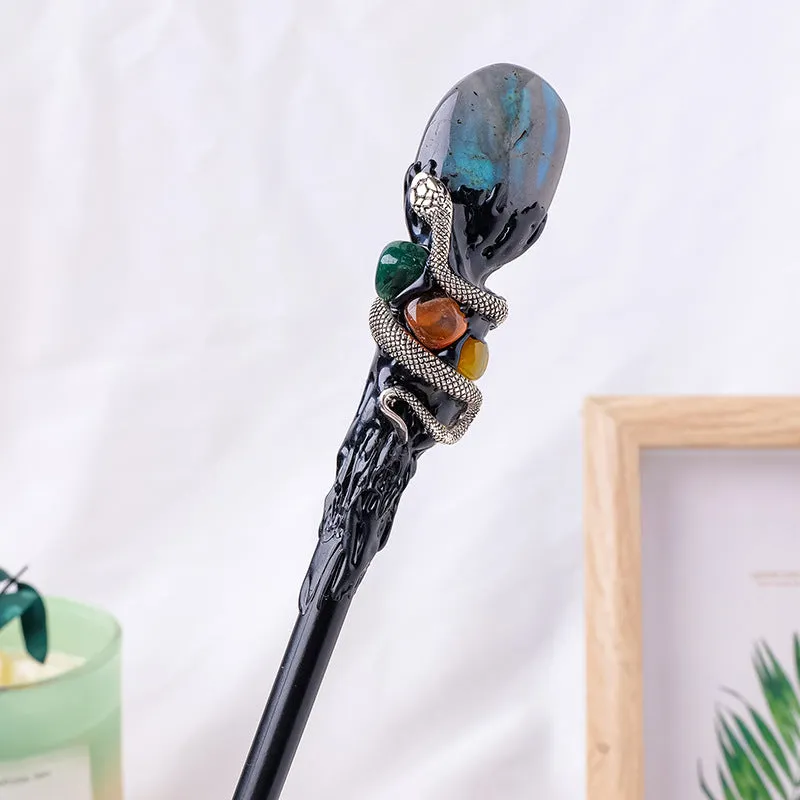 Natural crystal ball truncheon magic wand with amethyst stone ball on dark background